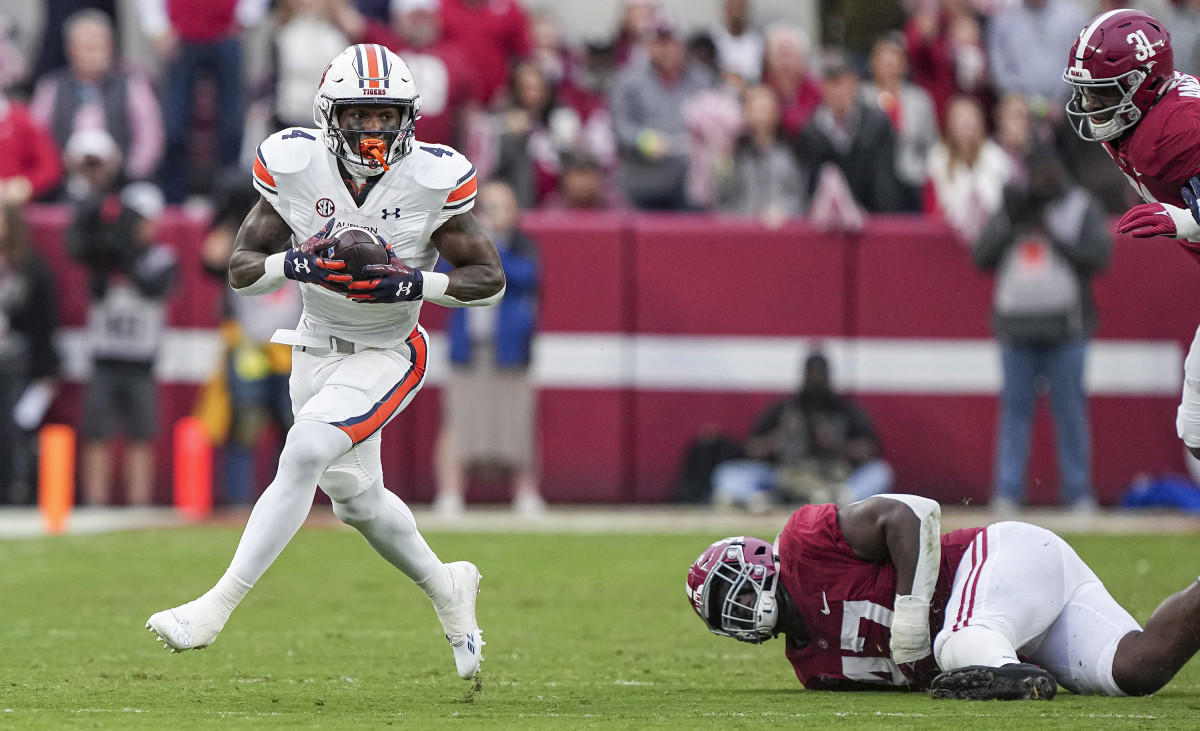 Tank Bigsby (4) makes a defender miss during the game between Auburn and Alabama at Bryant-Denny Stadium. Austin Perryman/AU Athletics